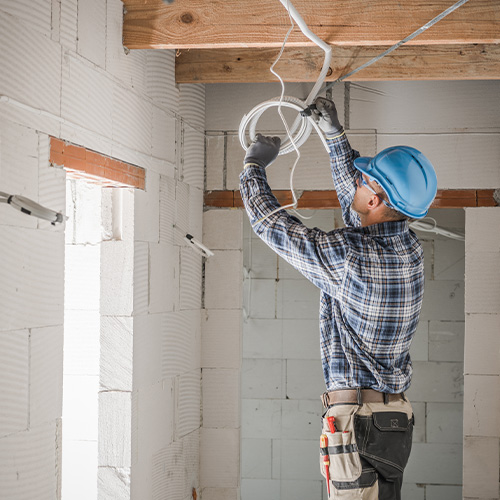 Worker Installing Electrical Cables Line

