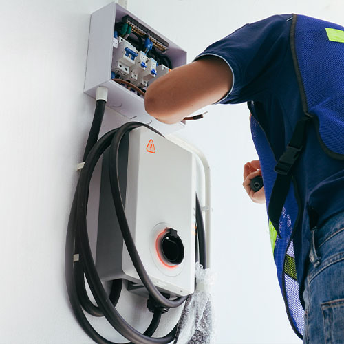 Certified male Electrician Installing Home EV Charger