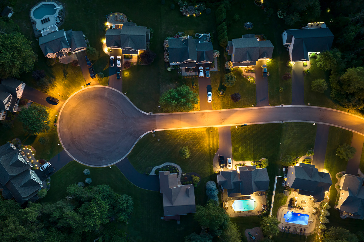 Residential illuminated homes at night in suburban sprawl development in Rochester, New York.