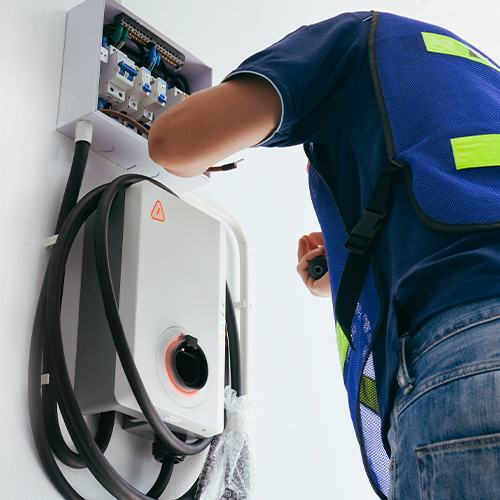 Certified male Electrician Installing Home EV Charger
