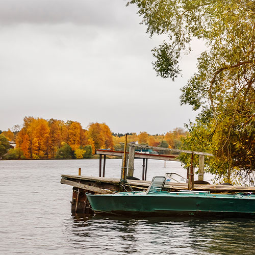 Boats at the pier in the autumn on cloudy afternoon.
