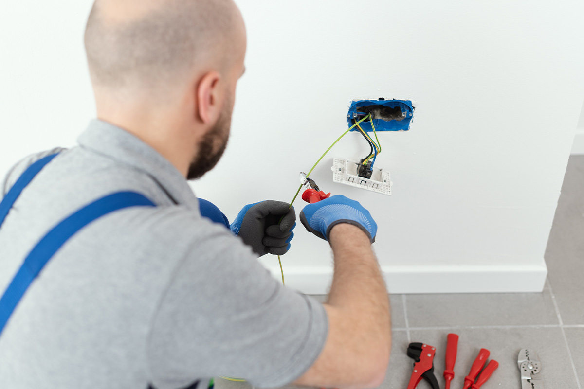 Professional electrician working on the electrical system, home improvement and repair concept