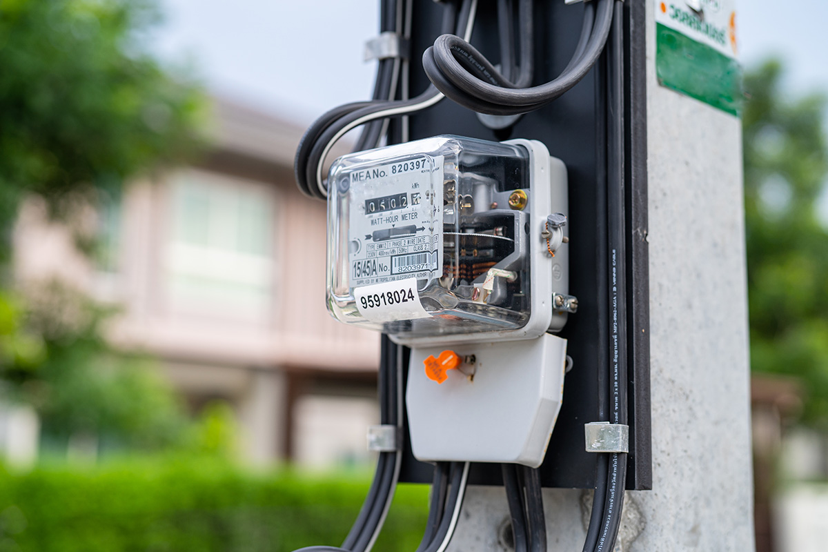 Electricity meter mounted on an outdoor panel.
